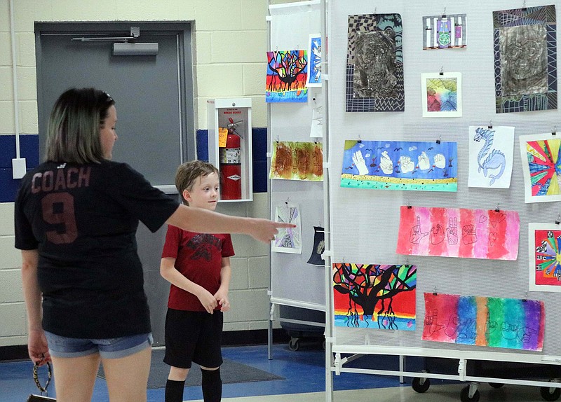 Visitors look at artworks on display during the annual school district student art show Thursday, May 12, 2022, in Redwater, Texas. (Submitted photo)