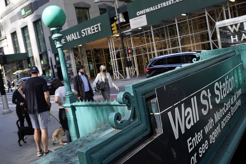 FILE - People walk on Broadway at Wall Street, Wednesday, June 16, 2021.  Stocks are opening lower on Wall Street, Wednesday, May 18, 2022, led by steep drops in retailers as Target plunged after issuing a grim quarterly earnings report. (AP Photo/Richard Drew, File)