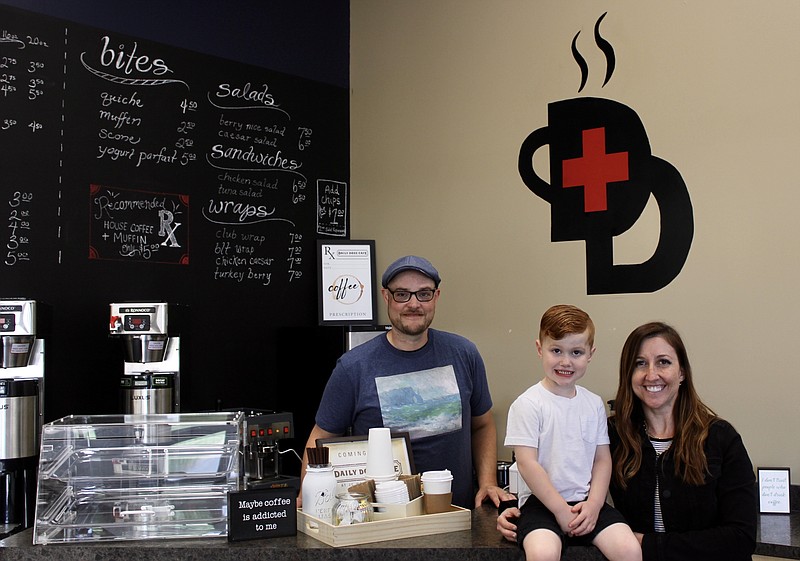 Daily Dose Cafe owners Joe Amsden (left) and Karina Amsden (right) pose with their son Liam (center) on Tuesday, May 17. (Cameron Gerber/News Tribune photo)