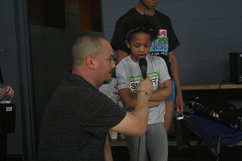 Adult adviser Steve Biernacki asks a student what they learned from the SMART Moves program during the completion ceremony at the Boys and Girls Club of El Dorado on Wednesday. (Matt Hutcheson/News-Times)
