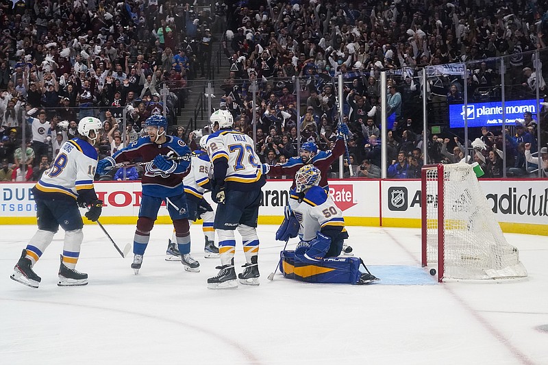 Colorado Avalanche left wing Gabriel Landeskog (92) and Nazem Kadri (91) celebrate an overtime goal by Josh Manson (42) against St. Louis Blues goaltender Jordan Binnington (50) in Game 1 of an NHL hockey Stanley Cup second-round playoff series Tuesday, May 17, 2022, in Denver. The Avalanche won 3-2. (AP Photo/Jack Dempsey)