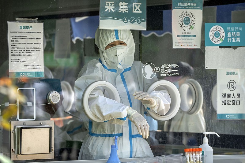 A worker waits for the next person Wednesday at a coronavirus testing site in Beijing. The number of cases has held steady but new clusters have popped up in different parts of the city.
(AP/Mark Schiefelbein)