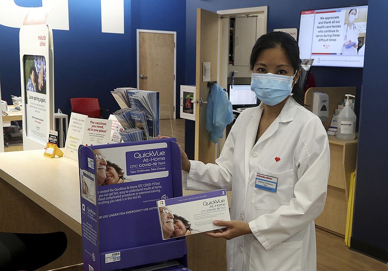 Nurse Practitioner Kathryn Pebanco displays some of the at home COVID-19 test kits at the MinuteClinic inside the CVS Pharmacy in Plantation on Friday, May 13, 2022. (Mike Stocker/Sun Sentinel/TNS)