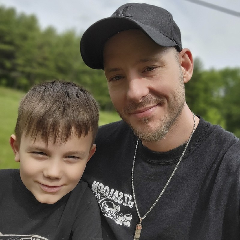 This 2021 photo provided by Billy Price shows him and his son, Maddox in Ohio. Price was already struggling to make ends meet before someone broke into his Michigan storage unit, stole his identity and ruined his credit. He filed a police report, and then tweeted about it to Bill Pulte, a multimillionaire who he'd heard uses Twitter to give money to those in need. (Billy Price via AP)