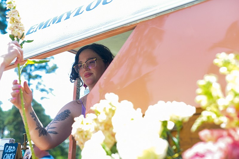 Brittney Tubs works a flower cart during the Twice as Fine Wine Festival on Saturday, May 7, 2022, at Spring Lake Park in Texarkana, Texas. (Staff photo by Erin DeBlanc)