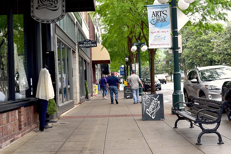Pedestrians stroll along downtown Hot Springs sidewalks in early May. - File photo by The Sentinel-Record