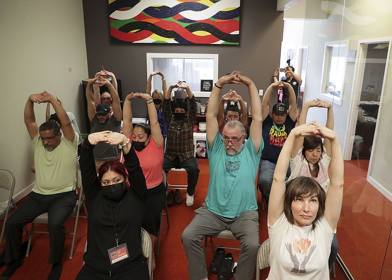 People participate in a mindfulness, stretching and meditation exercise during a wellness fair at Independent Drivers Guild (IDG) on May 12, 2022, in Park Ridge. (Stacey Wescott/Chicago Tribune/TNS)