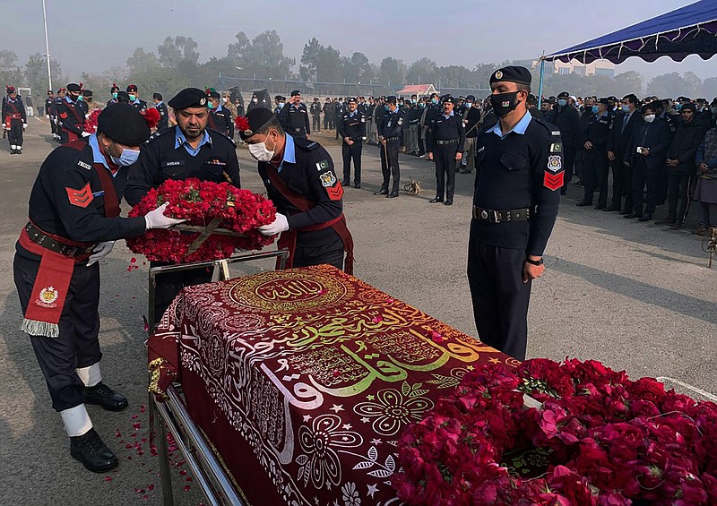 FILE- Police officers attend the funeral prayer of a colleague who was killed in an overnight attack by Pakistani Taliban who targeted police in multiple attacks in Islamabad and elsewhere in the country's northwest, in Islamabad, Pakistan, Jan. 18, 2022. Faced with rising violence, Pakistan is taking a tougher line to pressure Afghanistan’s Taliban rulers to crack down on militants hiding on their soil, but so far the Taliban remain reluctant to take action -- trying instead to broker a peace. (AP Photo, File)