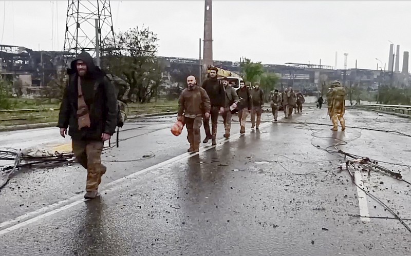 In this photo taken from video released by the Russian Defense Ministry on Thursday, May 19, 2022, shows Ukrainian servicemen as they leave the besieged Azovstal steel plant in Mariupol, in territory under the government of the Donetsk People's Republic, eastern Ukraine. (Russian Defense Ministry Press Service via AP)