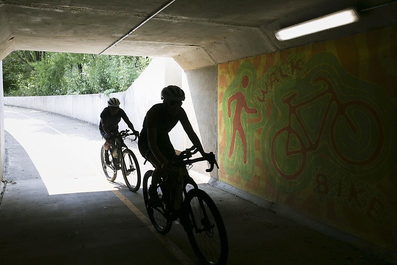 Bikers ride September 10, 2021, along the Razorback Greenway in Rogers. 
(NWA Democrat-Gazette/Charlie Kaijo)