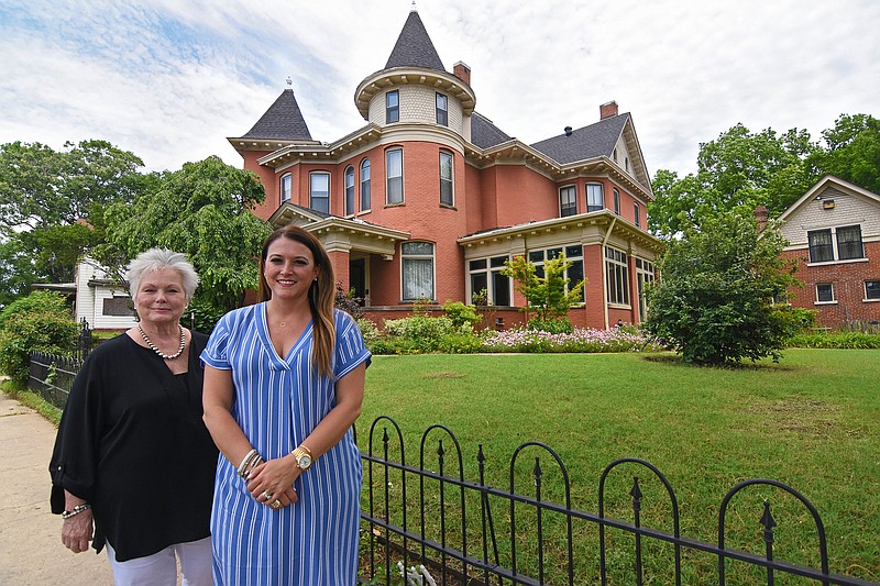Carolyn Cobb (left), executive broker, and Candice Whitlock, realtor, pose for a photo Thursday, May 19, 2022 in front of 500 E. 9th St. home for sale in Little Rock.
(Arkansas Democrat-Gazette/Staci Vandagriff)