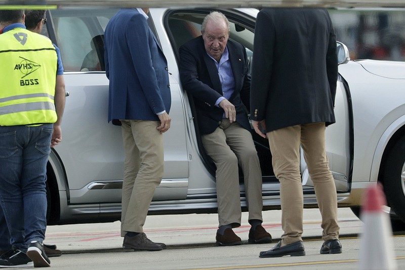Spain's former King Juan Carlos gets into a car on arrival by private jet at the Peinador airport in Vigo, north western Spain, Thursday, May 19, 2022. Spain's former King has returned to Spain Thursday for his first visit since leaving nearly two years ago amid a cloud of financial scandals.?(AP Photo/Lalo R. Villar)