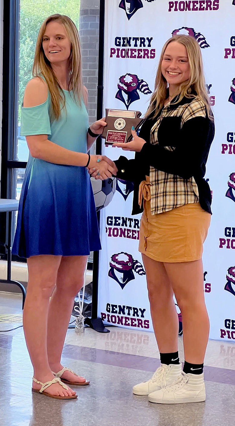 SUBMITTED
Gentry soccer player Kaitlyn Caswell (right) was selected to 4A-1 All-State. She receives a plaque from Jamie Johnson, head coach for the Gentry High School girls' soocer team.