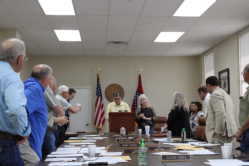 Members of the Union County Quorum Court applaud Treasurer Debbie Ray for her service to the county on Thursday. (Caitlan Butler/News-Times)
