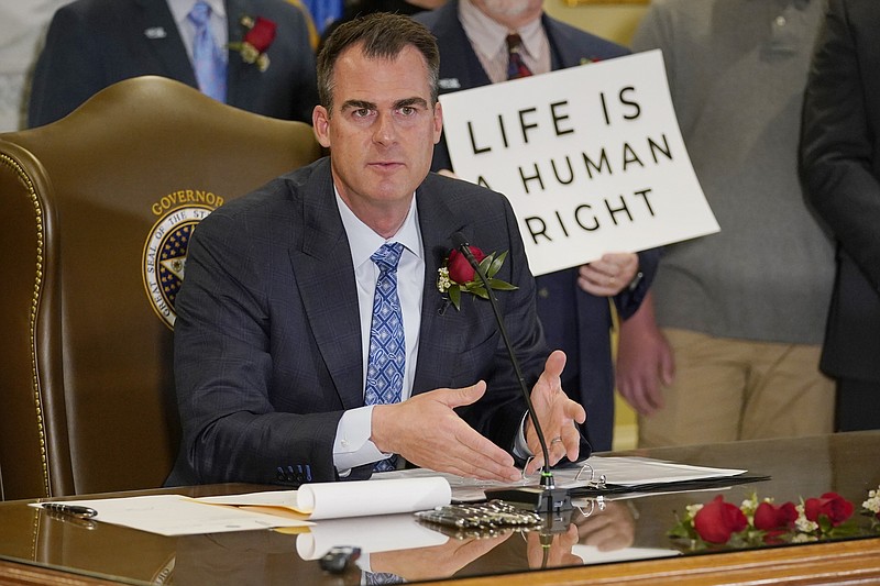 FILE -  In this April 12, 2022, file photo, Oklahoma Gov. Kevin Stitt speaks after signing into law a bill making it a felony to perform an abortion, punishable by up to 10 years in prison in Oklahoma City. Oklahoma's Legislature has given final legislative approval to another Texas-style anti-abortion bill. Abortion providers say once the bill is signed, it would be the most restrictive abortion ban in effect in the country. (AP Photo/Sue Ogrocki, file)