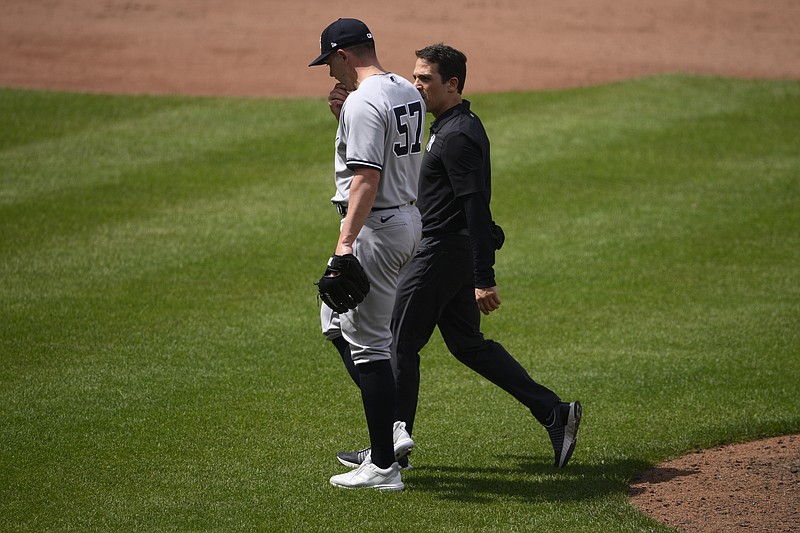 New York Yankees relief pitcher Chad Green (57) walks off the field with a trainer during the sixth inning of a baseball game against the Baltimore Orioles, Thursday, May 19, 2022, in Baltimore. The Orioles won 9-6. (AP Photo/Nick Wass)