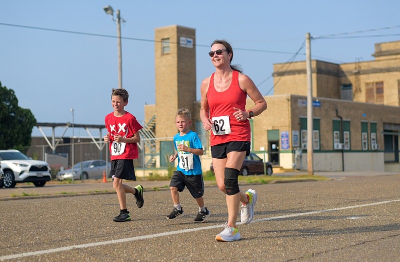 Chrissie Allen, Noah Thorton and Emmet Thorton cross the finish line in the All in for Autism 5K fundraiser benefiting the Greater Texarkana Autism Awareness organization. (Photo by Erin DeBlanc)