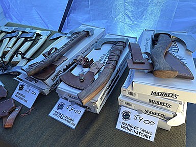 Hatchets on display at the Bombproof Bushcraft tent at the Homesteading and Prepping Summit at the St. John's County Fairgrounds in Elkton, Fla. on Saturday, April 24, 2022. (Christopher Spata/Tampa Bay Times/TNS)