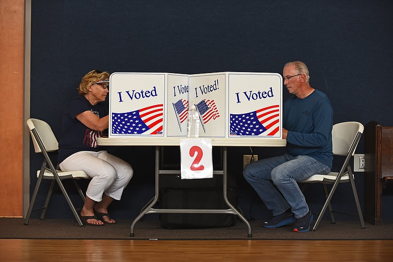 Suzie Mitchell and Greg Rusher, both of Sherwood, fill out their ballots during early voting Friday, May 20, 2022 at First Christian Church of Sherwood.
(Arkansas Democrat-Gazette/Staci Vandagriff)