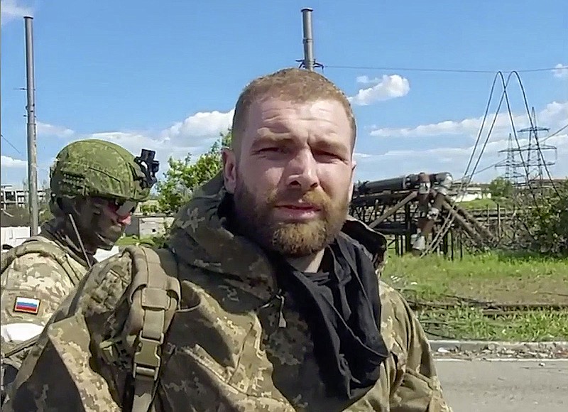 In this photo taken from video released by the Russian Defense Ministry on Saturday, May 21, 2022, Serhiy Volynskyy, nicknamed Volyna, commander of Ukraine's 36th Special Marine Brigade of Ukraine's Naval Forces lines up to be checked as he leaves the besieged Azovstal steel plant in Mariupol, in territory under the government of the Donetsk People's Republic, eastern Ukraine. (Russian Defense Ministry Press Service via AP)