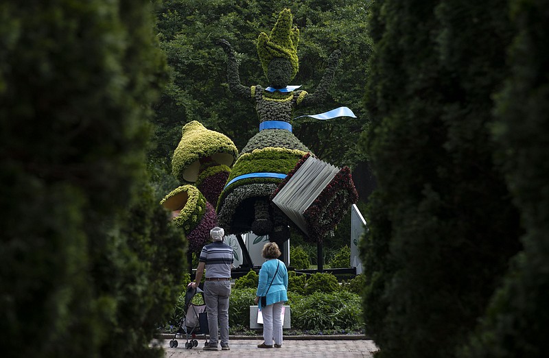 An Alice topiary stands in the “Alice’s Adventures in the Garden” exhibit at Memphis Botanic Garden Tuesday, May 10, 2022, in Memphis, Tenn. The exhibit will remain open until Oct. 31. (Christine Tannous//The Commercial Appeal via AP)