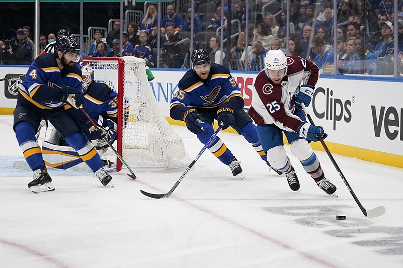 Colorado Avalanche's Logan O'Connor (25) handles the puck as St. Louis Blues' Nick Leddy (4) and Colton Parayko (55) defend during the third period in Game 3 of an NHL hockey Stanley Cup second-round playoff series Saturday, May 21, 2022, in St. Louis. (AP Photo/Jeff Roberson)