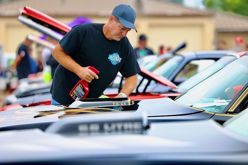 Henry Stacy of Rudy, Arkansas, cleans his 1977 Trans Am during the Show 'n' Shine event of Bandit Run on Sunday, May 22, 2022, at Four States Auto Museum in downtown Texarkana, Arkansas. The Bandit Run lets lovers of the 1977 hit re-enact its premise: an illegal transport of beer from Texarkana to Atlanta, Georgia. Many participants drive vintage Pontiac Trans Ams like the one driven by Burt Reynolds’ character in the movie. On Monday, May 23, 2022, the cars will travel to Vicksburg, Mississippi. The run ends Saturday, May 28, 2022, in Helen, Georgia. (Photo by JD)