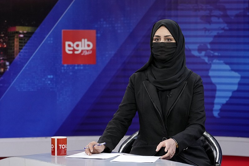 Khatereh Ahmadi a TV anchor wears a face covering as she reads the news on TOLO NEWS, in Kabul, Afghanistan, Sunday, May 22, 2022. Afghanistan's Taliban rulers have begun enforcing an order requiring all female TV news anchors in the country to cover their faces while on-air. The move Sunday is part of a hard-line shift drawing condemnation from rights activists. (AP Photo/Ebrahim Noroozi)