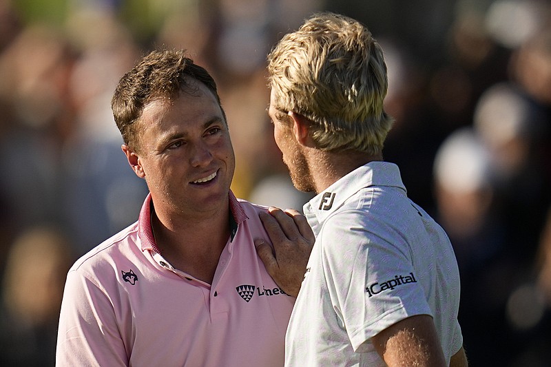 Justin Thomas, left, is greeted by Will Zalatoris after winning the PGA Championship golf tournament in a playoff at Southern Hills Country Club Sunday in Tulsa, Okla. - Photo by Sue Ogrocki of The Associated Press