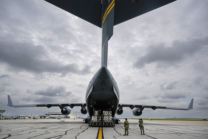 The crew of an Air Force C-17 begins to unload a plane load of baby formula at the Indianapolis International Airport in Indianapolis, Sunday, May 22, 2022. The 132 pallets of Nestl? Health Science Alfamino Infant and Alfamino Junior formula arrived from Ramstein Air Base in Germany (AP Photo/Michael Conroy)