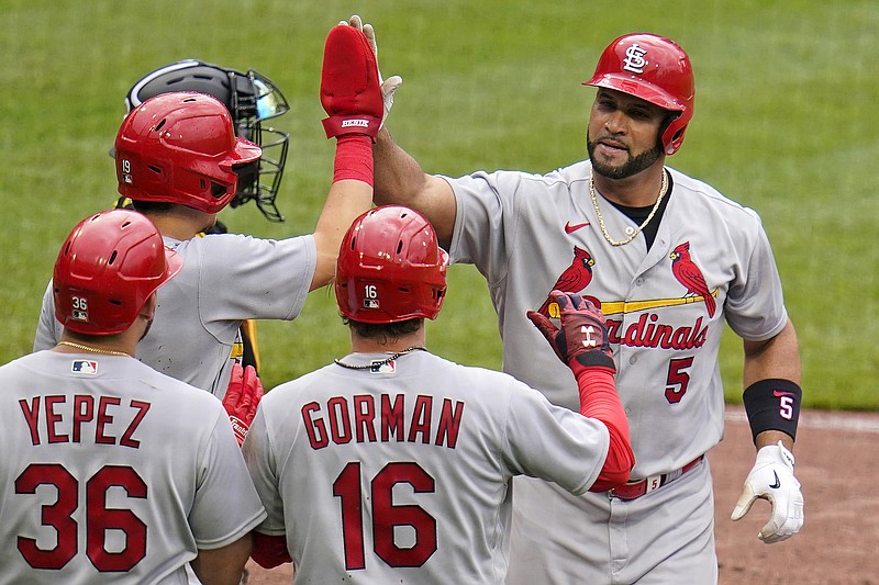 St. Louis Cardinals' Albert Pujols (5) returns to the dugout after hitting a three-run home run off Pittsburgh Pirates relief pitcher Josh VanMeter during the ninth inning of a baseball game in Pittsburgh, Sunday, May 22, 2022. (AP Photo/Gene J. Puskar)