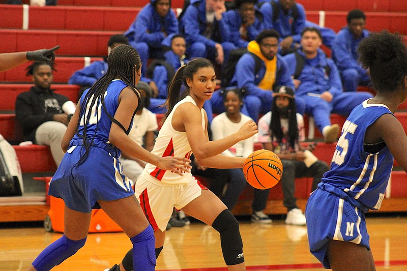 Photo By: Michael Hanich
Camden Fairview forward Karmen Johnson moves around the defenders of Monticello.