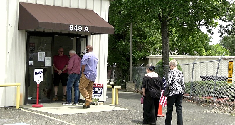 Voters line up outside the Garland County Election Commission Building Monday, the last day of early voting for today’s party primaries and nonpartisan general election. - Photo by Andrew Mobley of The Sentinel-Record