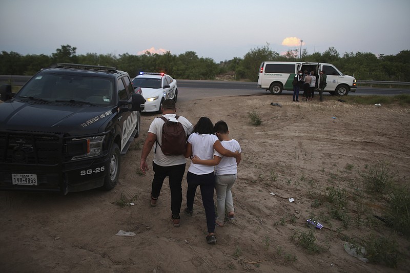 A migrant family who earlier crossed the Rio Grande river into the United States is taken away by Border Patrol agents in Eagle Pass, Texas, Saturday, May 21, 2022. The Eagle Pass area has become increasingly a popular crossing corridor for migrants, especially those from outside Mexico and Central America, under Title 42 authority, which expels migrants without a chance to seek asylum on grounds of preventing the spread of COVID-19. (AP Photo/Dario Lopez-Mills)