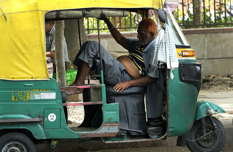 An auto rickshaw driver exhausted from intense heat rests in his vehicle, in New Delhi, Thursday, May 19, 2022. The intense heat wave sweeping through South Asia was made more likely due to climate change and it is a sign of things to come. An analysis by international scientists said that this heat wave was made 30-times more likely because of climate change, and future warming would make heat waves more common and hotter in the future. (AP Photo/Manish Swarup)