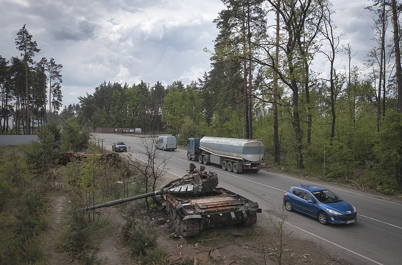 The Associated Press
Cars pass by Russian tanks destroyed in a recent battle against Ukrainians in the village of Dmytrivka, close to Kyiv, Ukraine, on Monday.