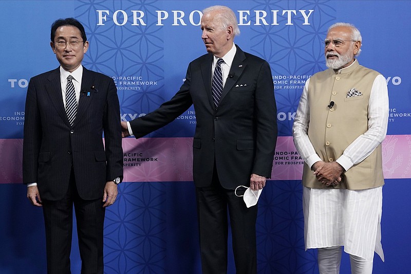 Japanese Prime Minister Fumio Kishida, left, President Joe Biden and Indian Prime Minister Narendra Modi pose for photos as they arrive at the Indo-Pacific Economic Framework for Prosperity launch event at the Izumi Garden Gallery, Monday, May 23, 2022, in Tokyo. (AP Photo/Evan Vucci)