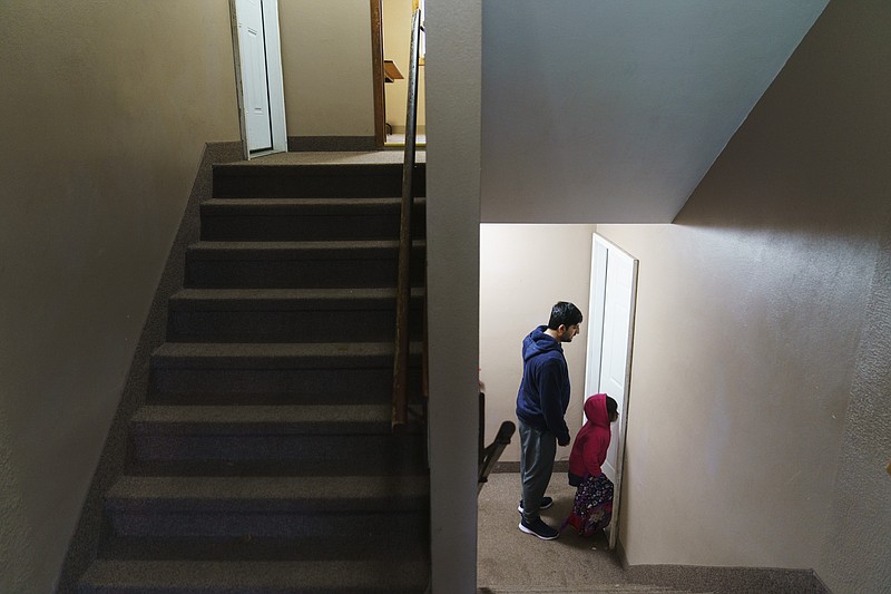 FILE - Ihsanullah Patan, an agricultural specialist and refugee from Afghanistan, and his daughter, Sujda, 5, return home after picking her up from daycare in Fergus Falls, Minn., Wednesday, Oct. 27, 2021. The number of people forced to flee conflict, violence, human rights violations and persecution has crossed the milestone of 100 million for the first time on record, propelled by the war in Ukraine and other deadly conflicts, The U.N. refugee agency said Monday, May 23, 2022.  (AP Photo/David Goldman, File)