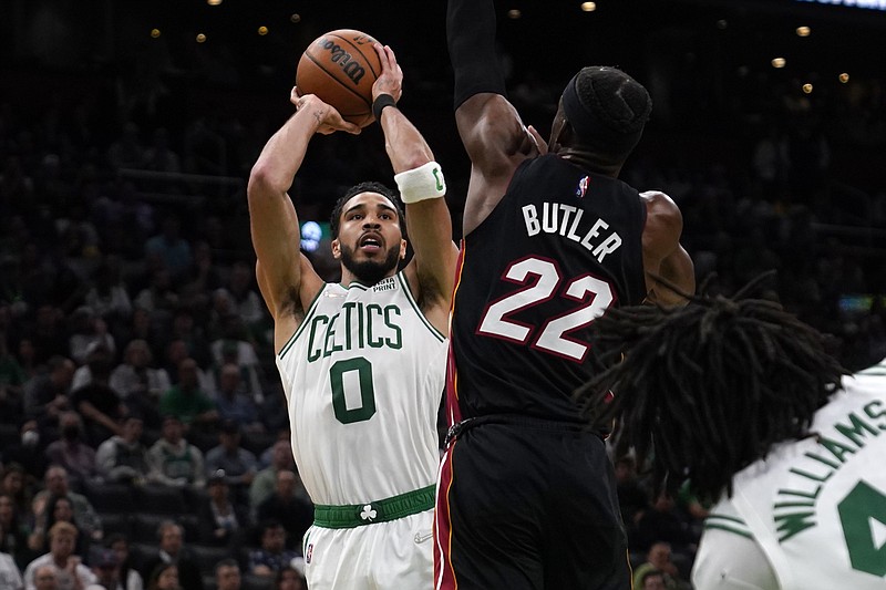 Boston Celtics forward Jayson Tatum (0) shoots over Miami Heat forward Jimmy Butler (22) during the second half of Game 4 of the NBA basketball playoffs Eastern Conference finals, Monday, May 23, 2022, in Boston. (AP Photo/Charles Krupa)