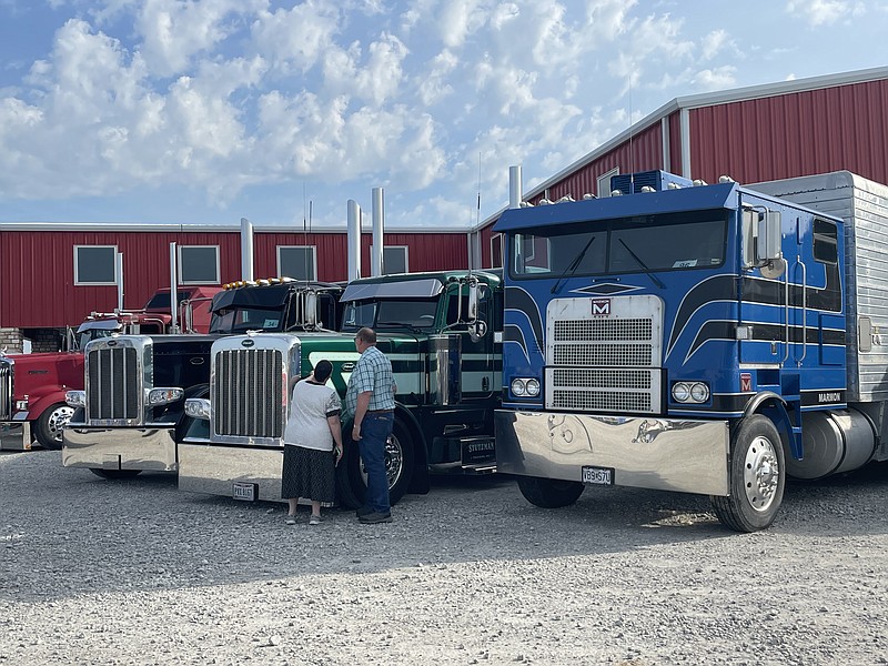Attendees get an up-close look at semitrucks as they arrive during the second annual Crossroads Truck Meet event on May 14, 2022. Rigs gathered at the Crossroads Shopping Plaza for truck show and Convoy for Camp benefitting Wonderland Camp. (Democrat photo/Kaden Quinn photo)