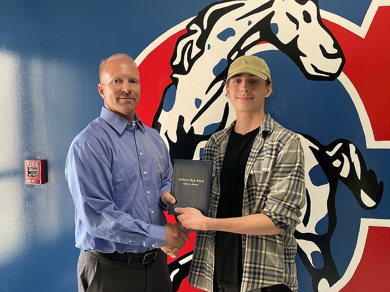 California R-1 School Board President Derek VanLoo awards California High School student Treavor Peacher with his diploma May 11, 2022, during the school board meeting. (Democrat photo/Kaden Quinn)