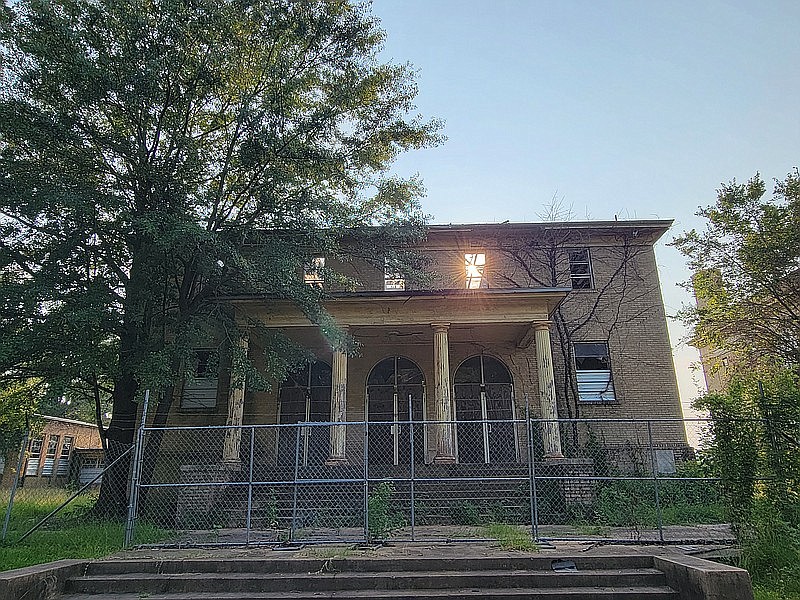 Sunlight glares through an open window at the old Pine Street Junior High School campus, made possible because there is no longer a roof above it. (Gazette file photo)