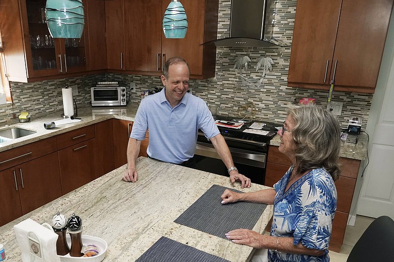 Mark Bendell and his wife Laurie talk in their kitchen, Monday, May 23, 2022, in Boca Raton, Fla. A stock market slump this year, which has taken big bites out of investors? portfolios, including retirement plans like 401(k)s, is worrying Americans who are within a few years of retirement. (AP Photo/Marta Lavandier)