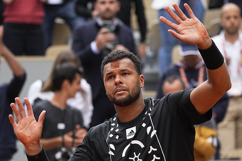 France's Jo-Wilfried Tsonga has a mark on his forehead after kissing the clay after losing to Norway's Casper Ruud in a first round match of the French Open tennis tournament at the Roland Garros stadium Tuesday, May 24, 2022 in Paris. The Frenchman retired following his first-round loss against Casper Ruud. (AP Photo/Michel Euler)