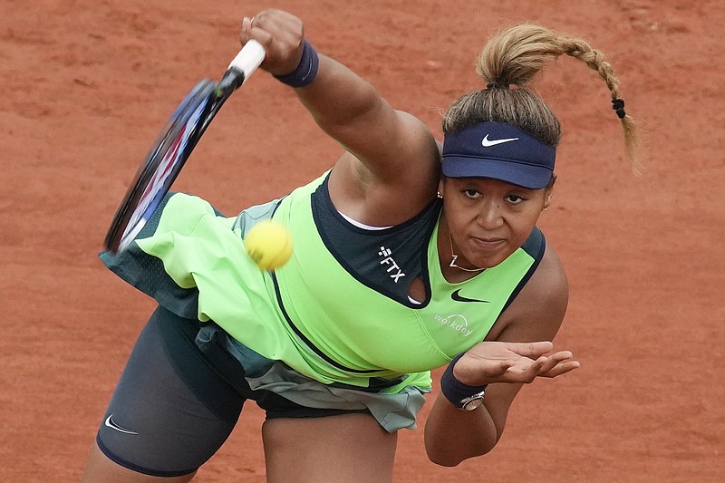 Japan's Naomi Osaka serves against Amanda Anisimova of the U.S. during their first round match at the French Open Monday in Roland Garros stadium in Paris. The players remaining in the tournament see and hear products of Osaka's frank discussion about anxiety and depression a year ago -- from new "quiet rooms" and on-call psychiatrists at Roland Garros to a broader sense that mental health is a far-less-taboo topic than it once was. - Photo by Christophe Ena of The Associated Press
