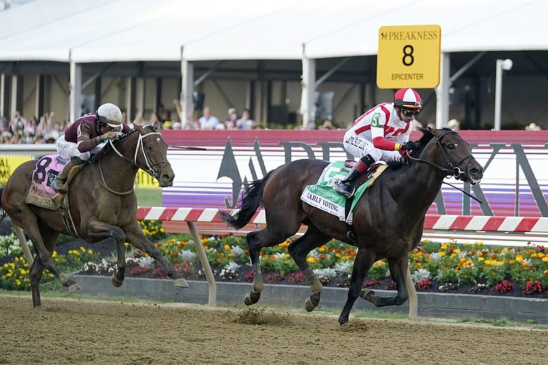 Jose Ortiz, right, atop Early Voting, heads to the finish line with Joel Rosario, atop Epicenter, at his tail before winning the 147th running of the Preakness Stakes at Pimlico Race Course Saturday in Baltimore. - Photo by Julio Cortez of The Associated Press