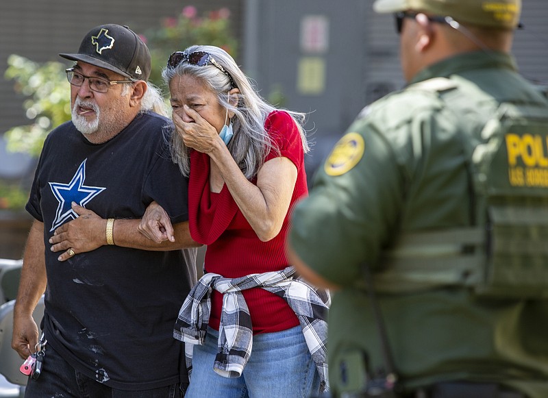 William Luther/The San Antonio Express-News via AP
A woman cries as she leaves the Uvalde Civic Center, on Tuesday in Uvalde, Texas An 18-year-old gunman opened fire Tuesday at a Texas elementary school, killing multiple children and a teacher and wounding others, Gov. Greg Abbott said, and the gunman was dead.