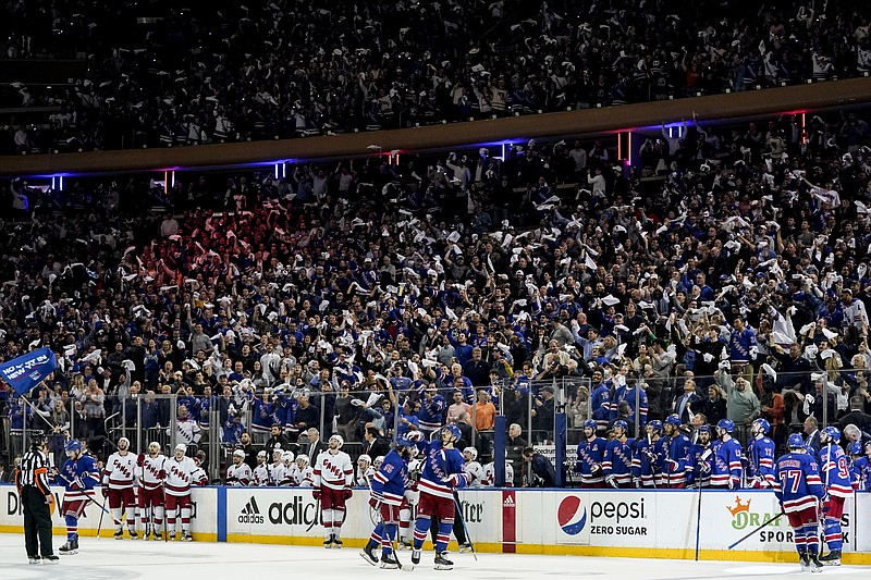 New York Rangers fans react after center Mika Zibanejad (93) scores on Carolina Hurricanes goaltender Antti Raanta in the second period of Game 4 of an NHL hockey Stanley Cup second-round playoff series, Tuesday, May 24, 2022, in New York. (AP Photo/John Minchillo)