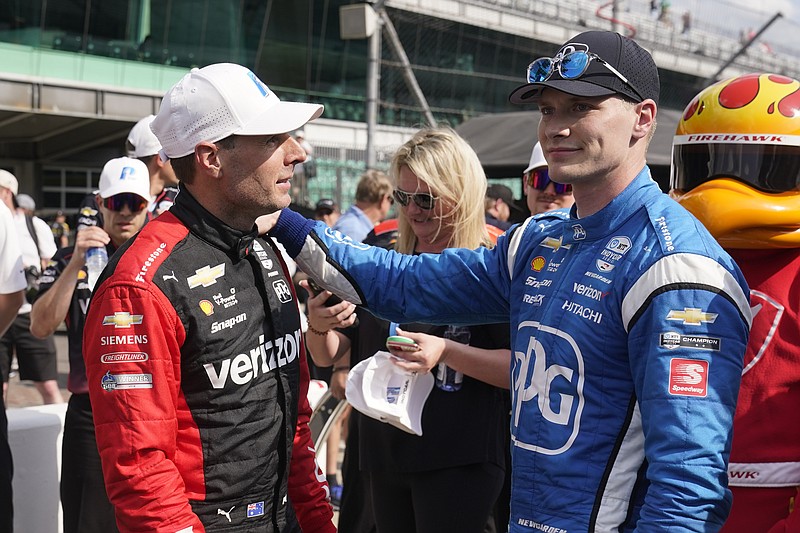 Will Power, left, of Australia, is congratulated by Josef Newgarden after Power won the pole for the IndyCar auto race at Indianapolis Motor Speedway, Friday, May 13, 2022, in Indianapolis. (AP Photo/Darron Cummings)