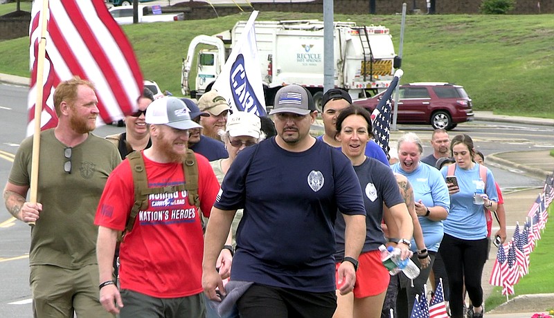 The relay nears the end of its Hot Springs leg. - Photo by Andrew Mobley of The Sentinel-Record.